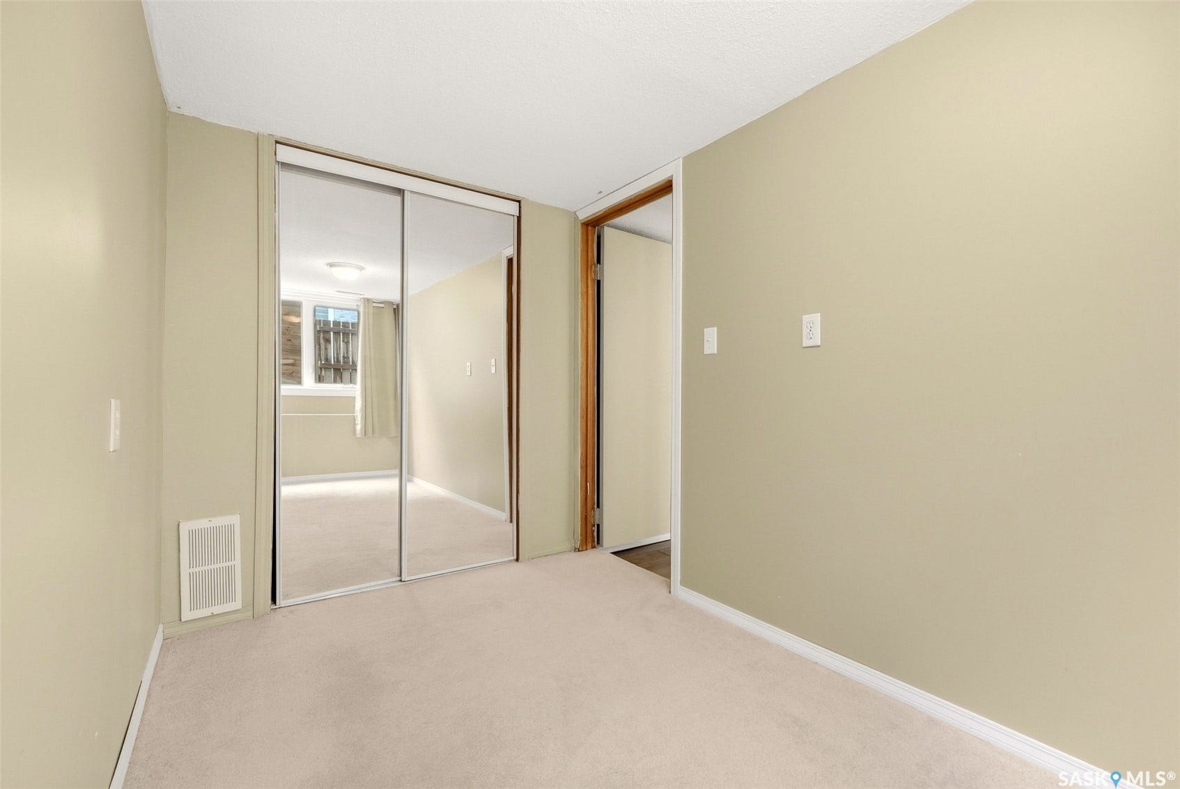 Wall-to-wall carpeting and sliding mirrored closet doors