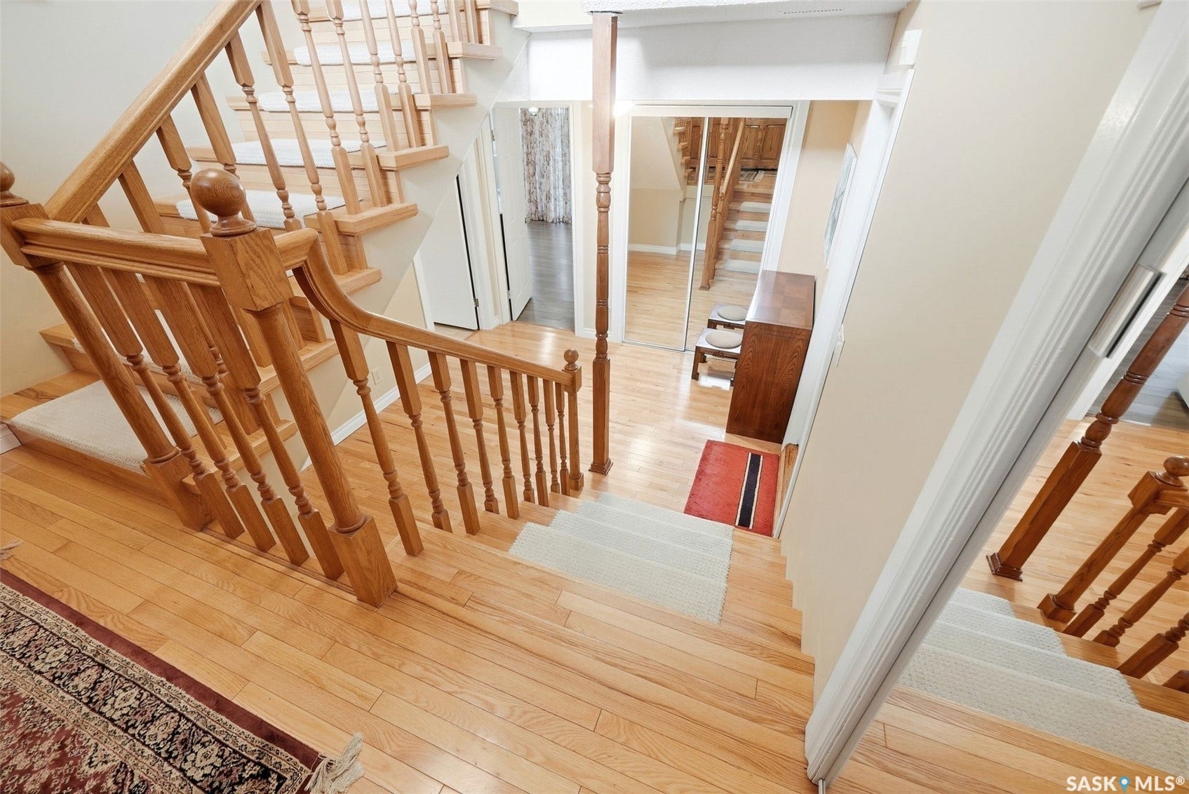 Hardwood flooring and staircase with wood balusters