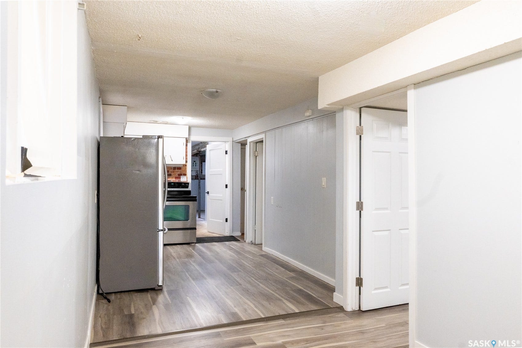 2232 McAra Street, Regina SK S4N 2W1 Wood-finish flooring, white paneled doors, stainless steel refrigerator, and stainless steel oven