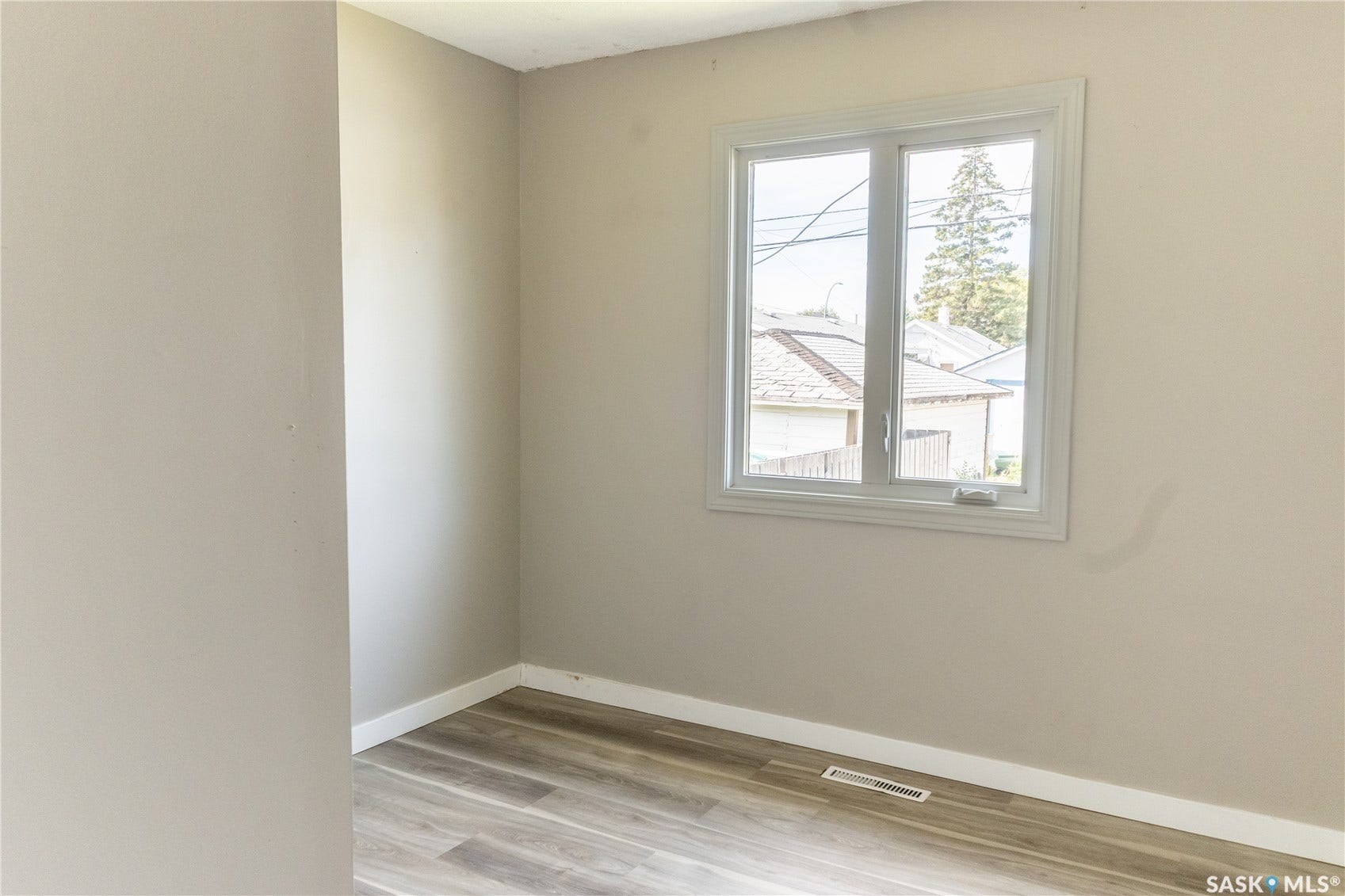 2232 McAra Street, Regina SK S4N 2W1 Light-toned walls, wood-finish flooring, and a white-framed window