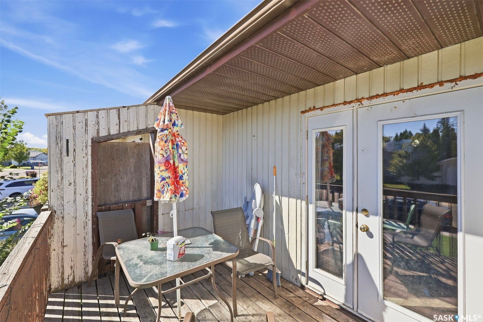 Wood deck with a partial overhang and exterior siding