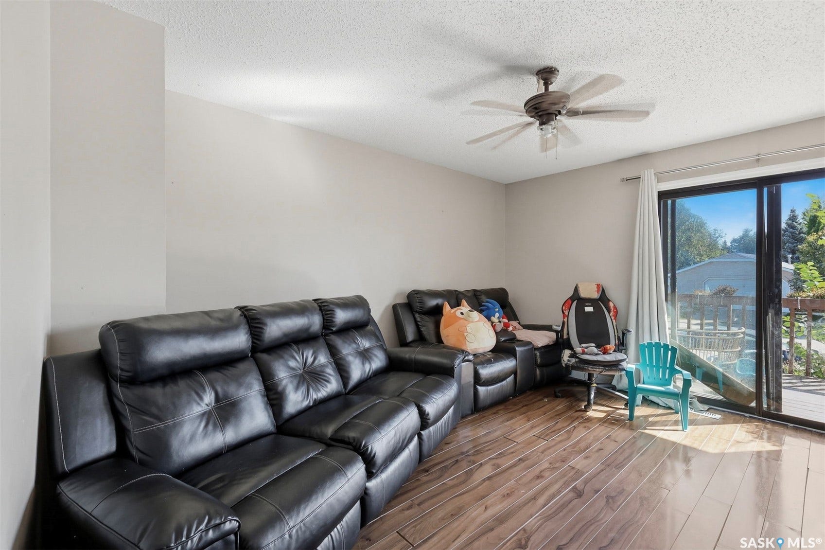 Wood-finish flooring, ceiling fan, and sliding glass door