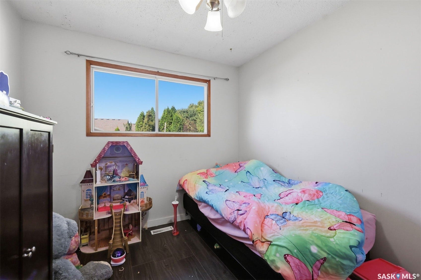 Wood-finish flooring with a ceiling-mounted light fixture