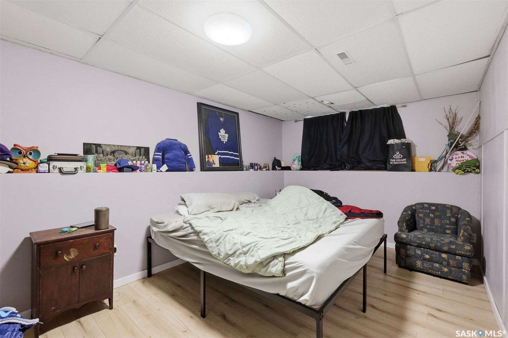 Wood-finish flooring with a drop ceiling and recessed lighting