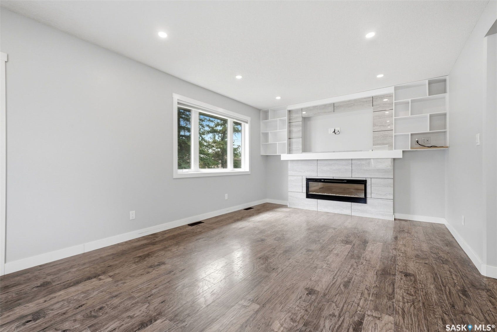 1601 Lacon Street, Regina SK S4N 1Z5 Wood-finish flooring, recessed lighting, and a window with white trim
