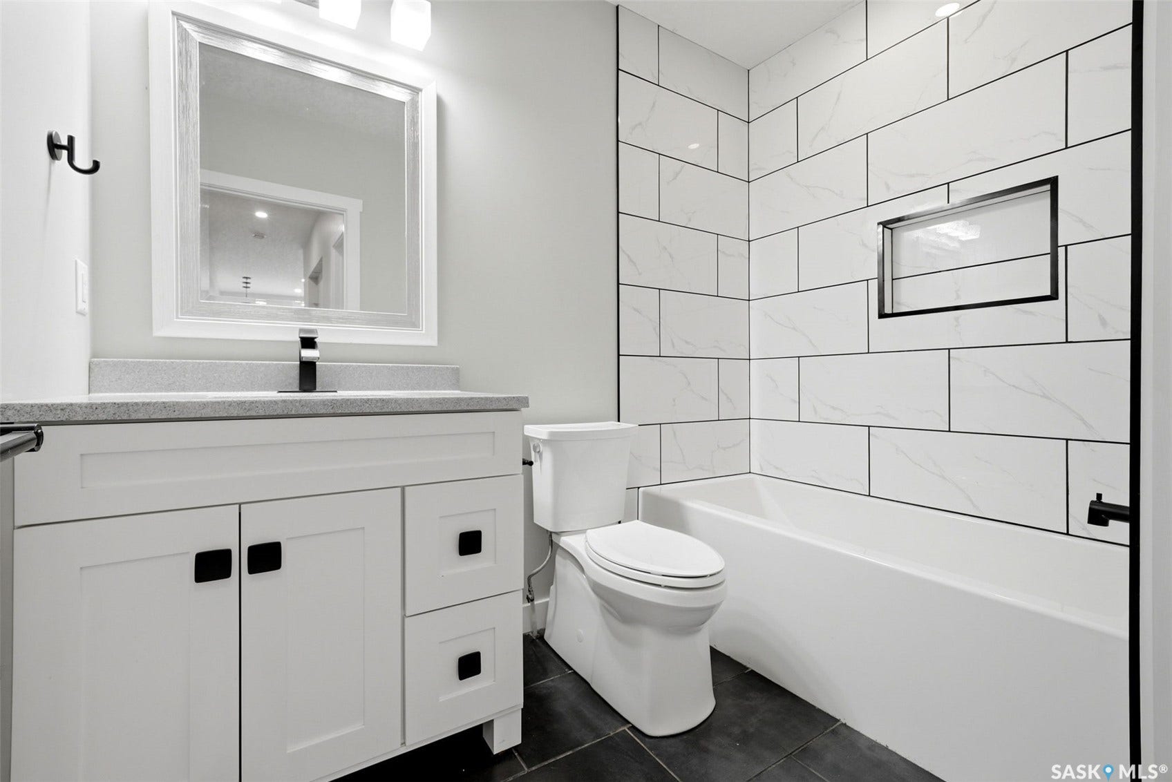 1601 Lacon Street, Regina SK S4N 1Z5 White shaker-style vanity with matte black hardware