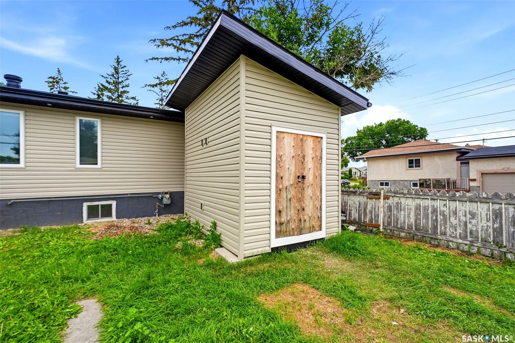 1601 Lacon Street, Regina SK S4N 1Z5 Beige vinyl siding with a dark roofline and white window trim
