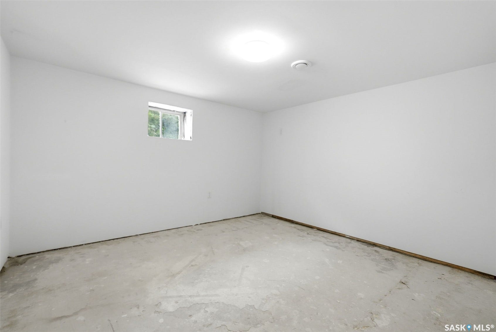 1601 Lacon Street, Regina SK S4N 1Z5 Recessed ceiling light, white painted walls, and a single-pane window