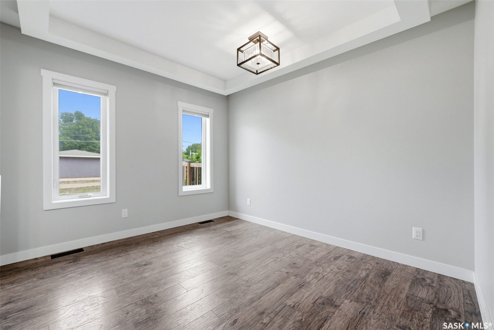 1601 Lacon Street, Regina SK S4N 1Z5 Wood-finish flooring, recessed ceiling with white trim, dual windows, and a modern ceiling fixture