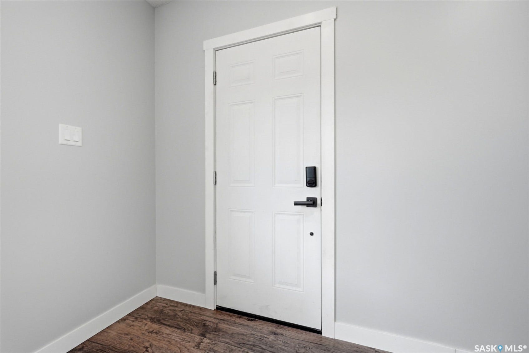 1601 Lacon Street, Regina SK S4N 1Z5 Paneled interior door with matte black hardware, digital lock, and contrasting white trim