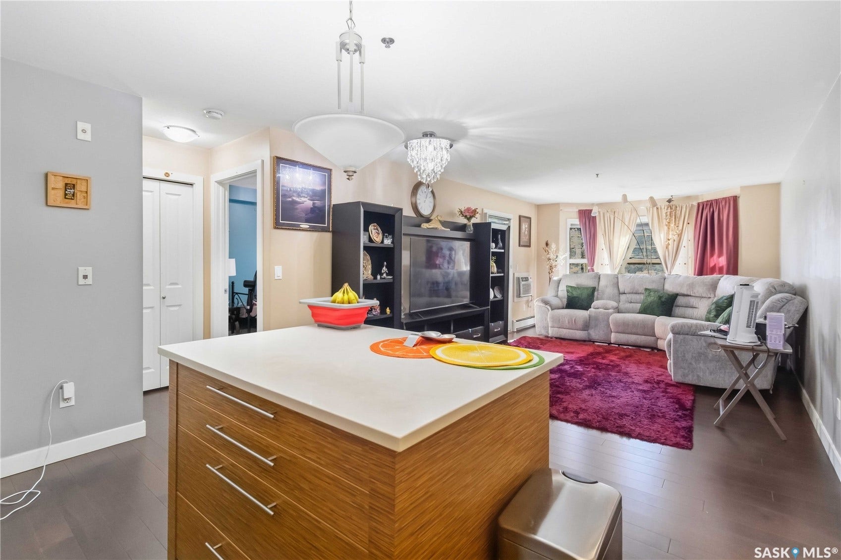 Kitchen island with wood-finish cabinetry and light-toned countertop