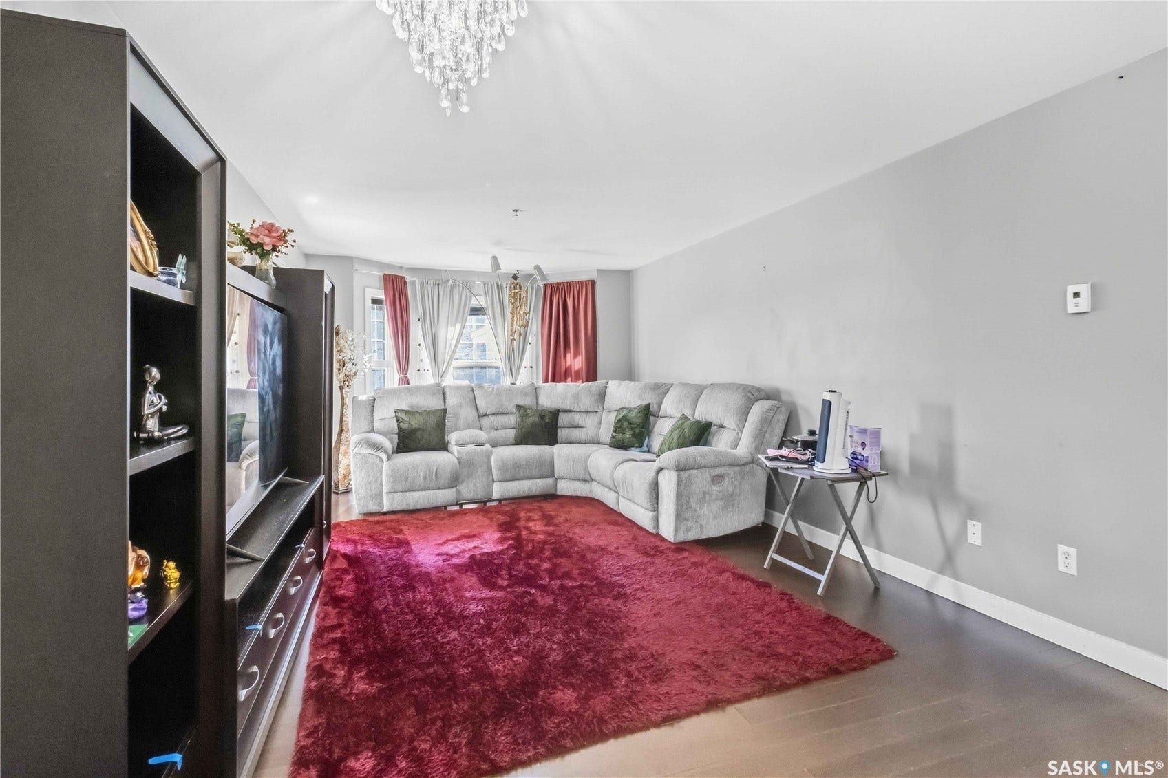 Recessed lighting and ceiling-mounted chandelier illuminate the space