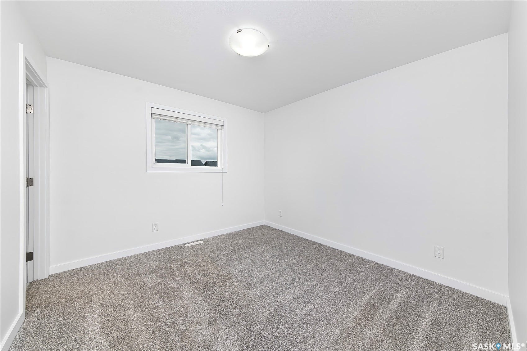 White-painted walls and trim with light gray carpeting