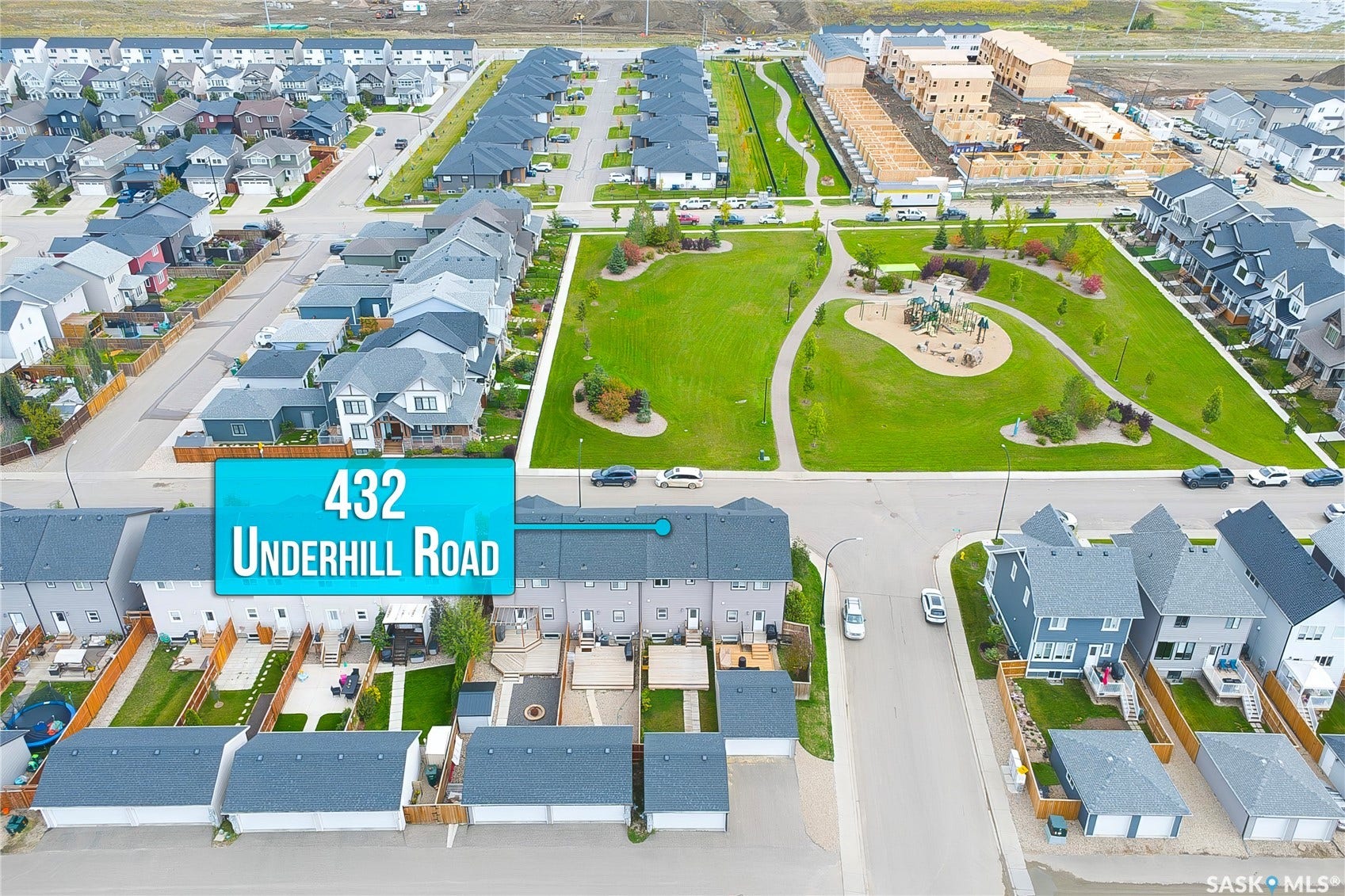 Townhome property with private fenced backyard, detached garage, and direct access to green space featuring a playground