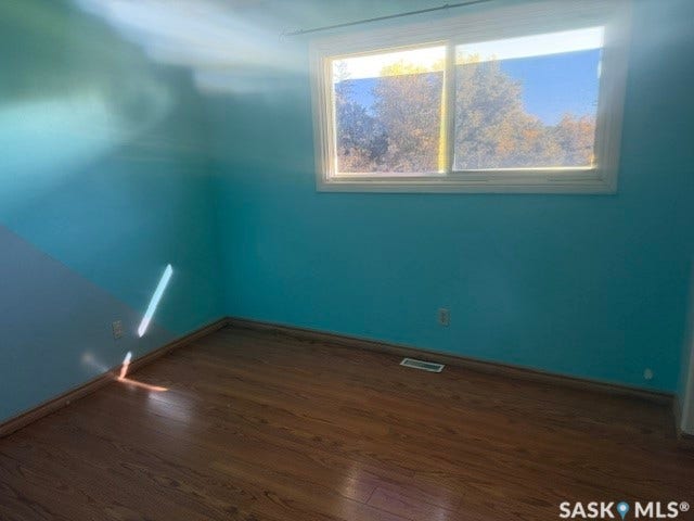 Wood-finish flooring with a white-framed window
