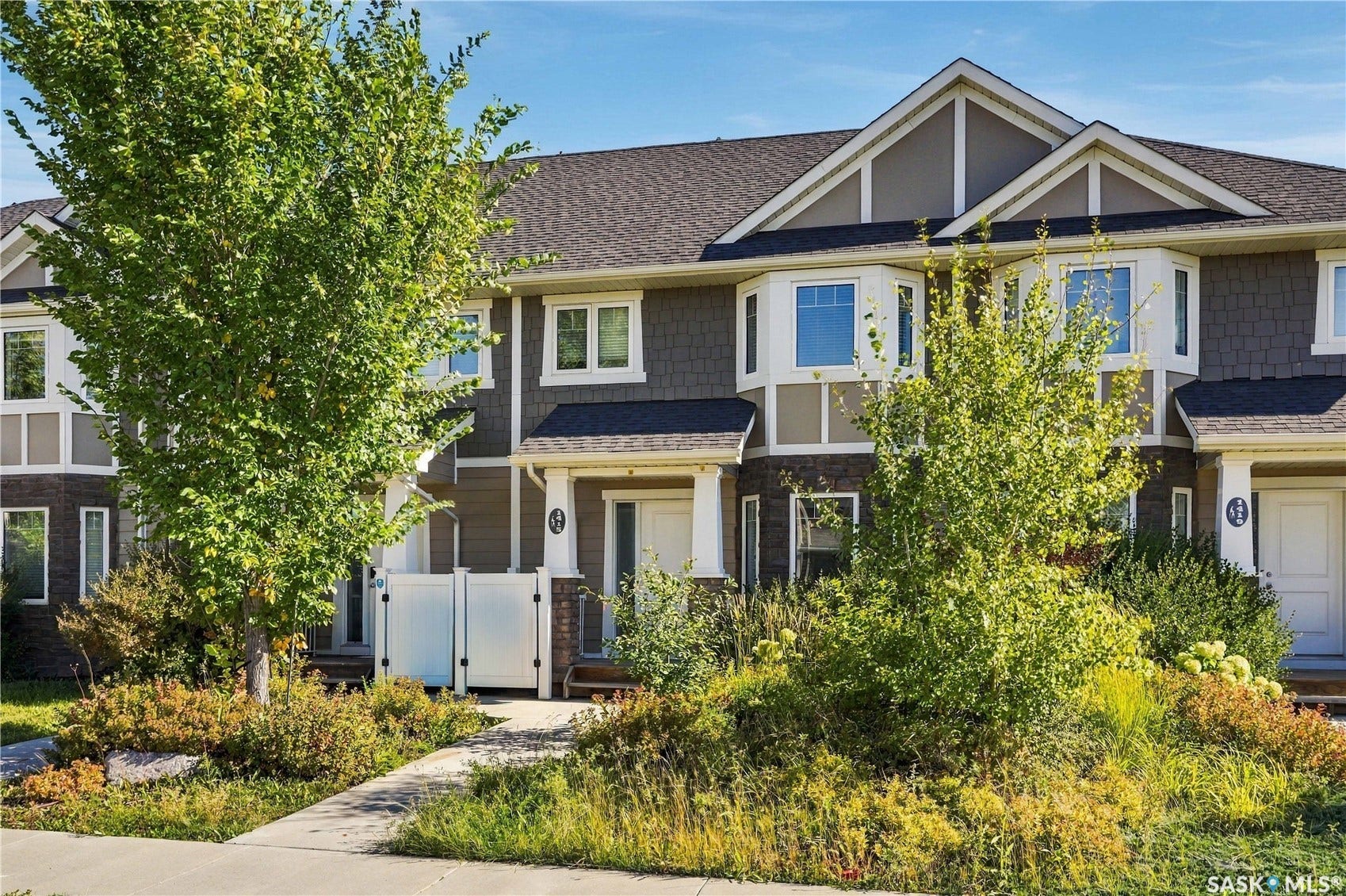 Townhome exterior with shingle siding and gabled rooflines
