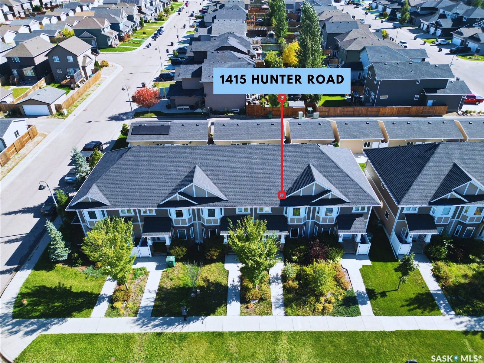 Townhome-style exterior with gabled roofline and multiple windows