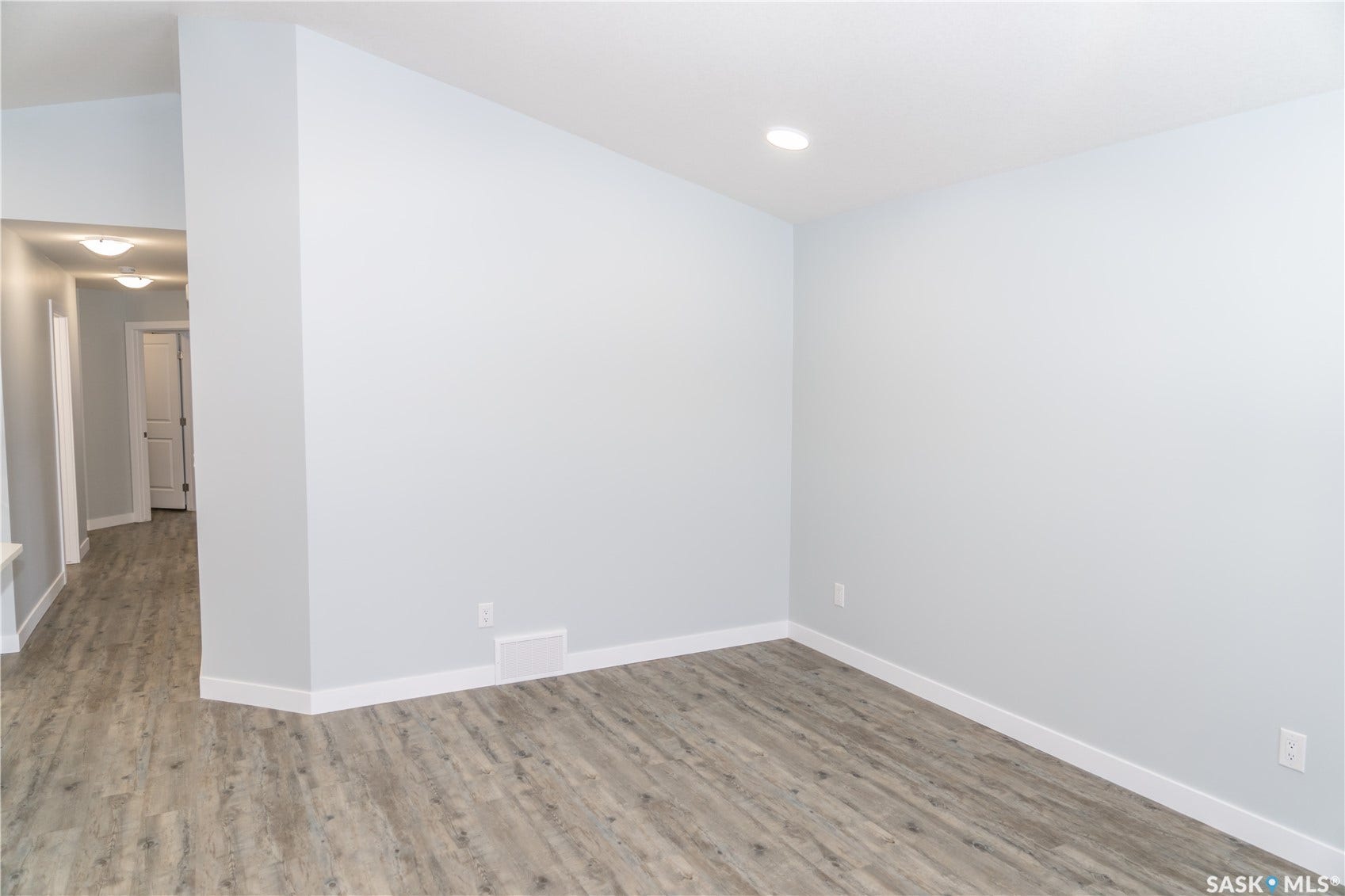 306 Stehwien Street, Saskatoon SK S7W 1P3 Spare room featuring light hardwood / wood-style flooring and vaulted ceiling