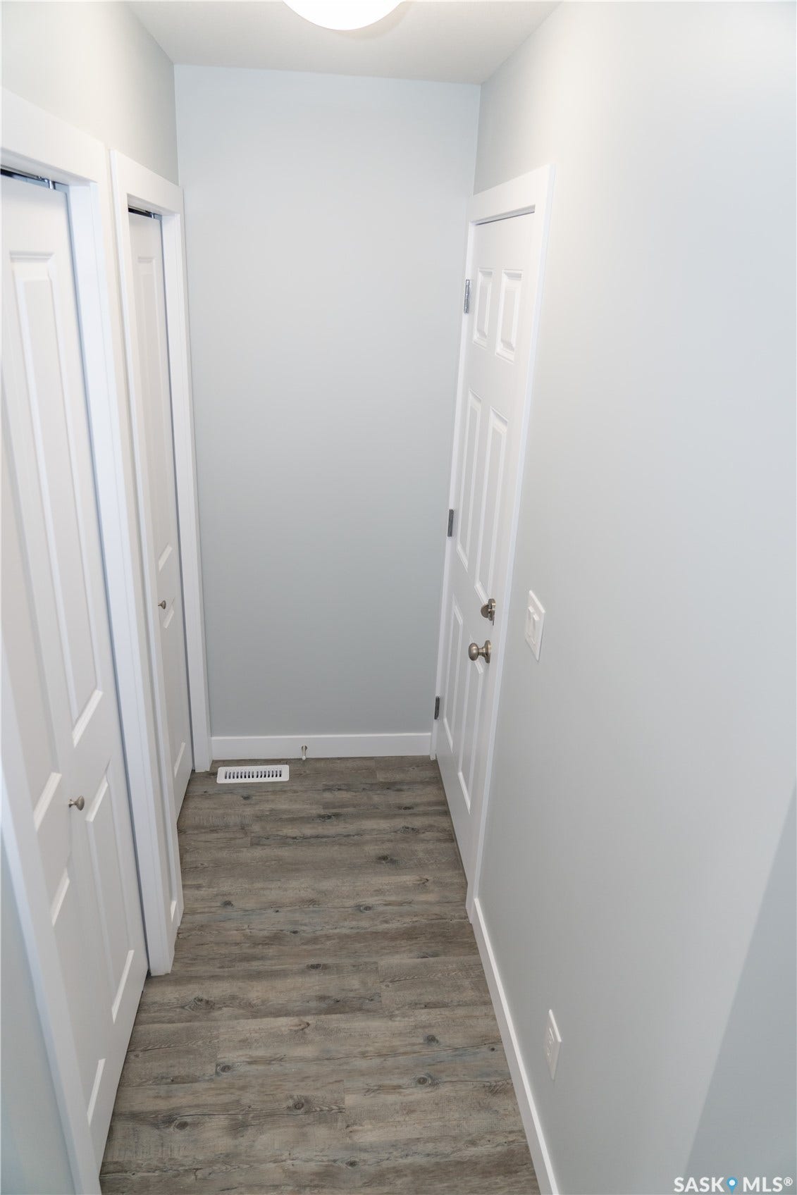 306 Stehwien Street, Saskatoon SK S7W 1P3 Corridor featuring dark hardwood / wood-style flooring