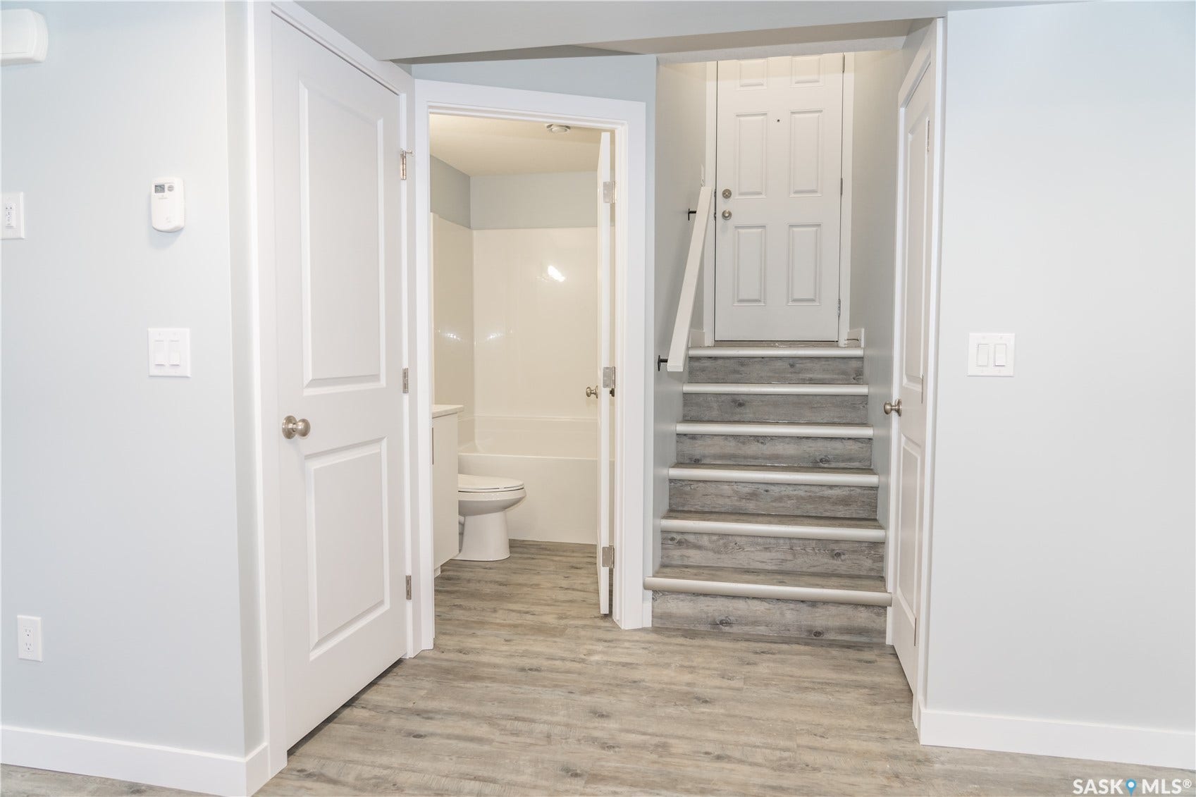 306 Stehwien Street, Saskatoon SK S7W 1P3 Stairway with light hardwood / wood-style flooring