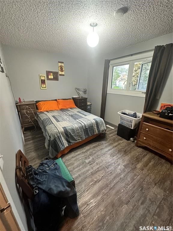 Wood-finish flooring, single window, and overhead lighting fixture