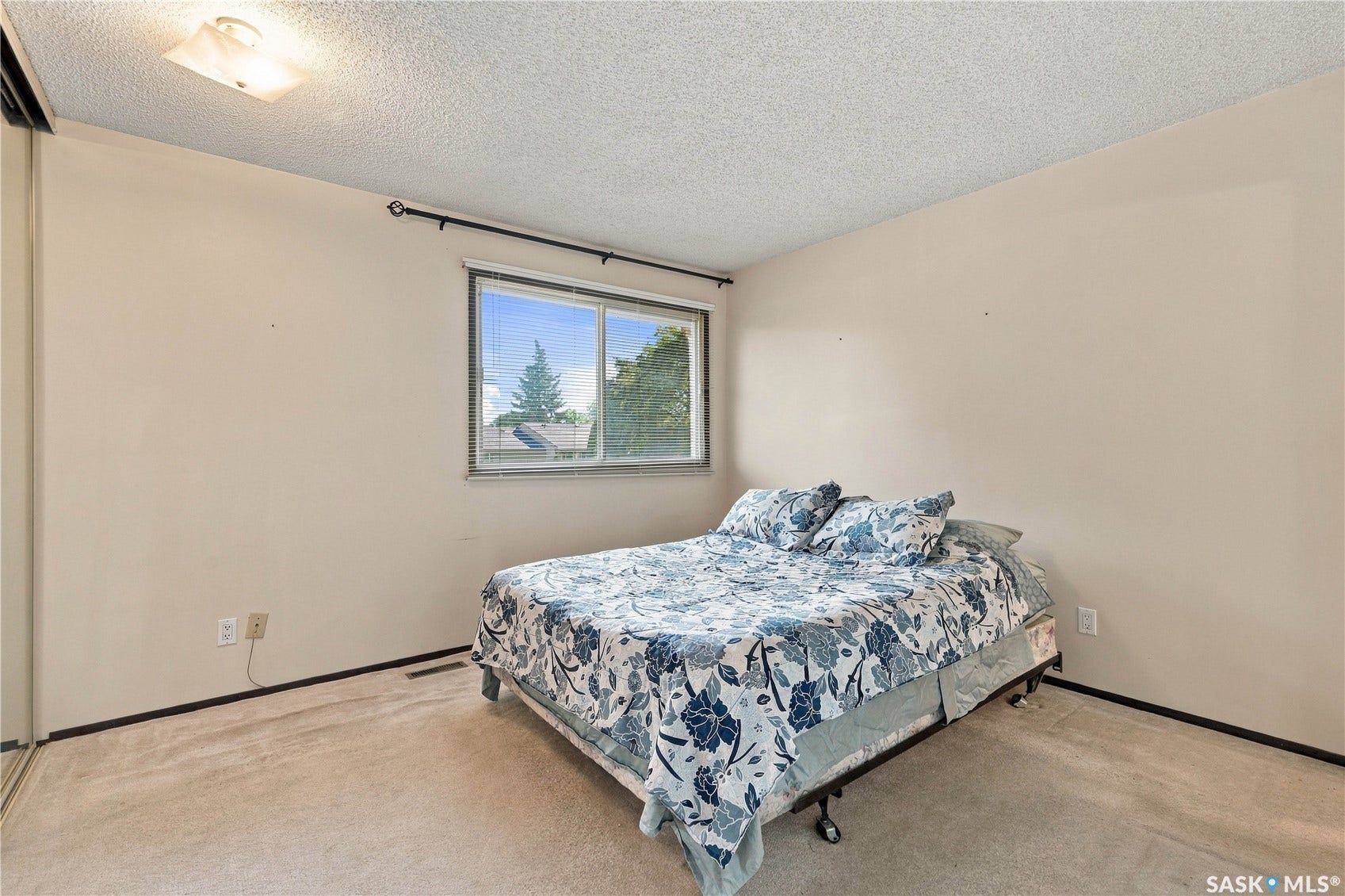 Recessed lighting, wall-to-wall carpeting, and a window with exterior scenery