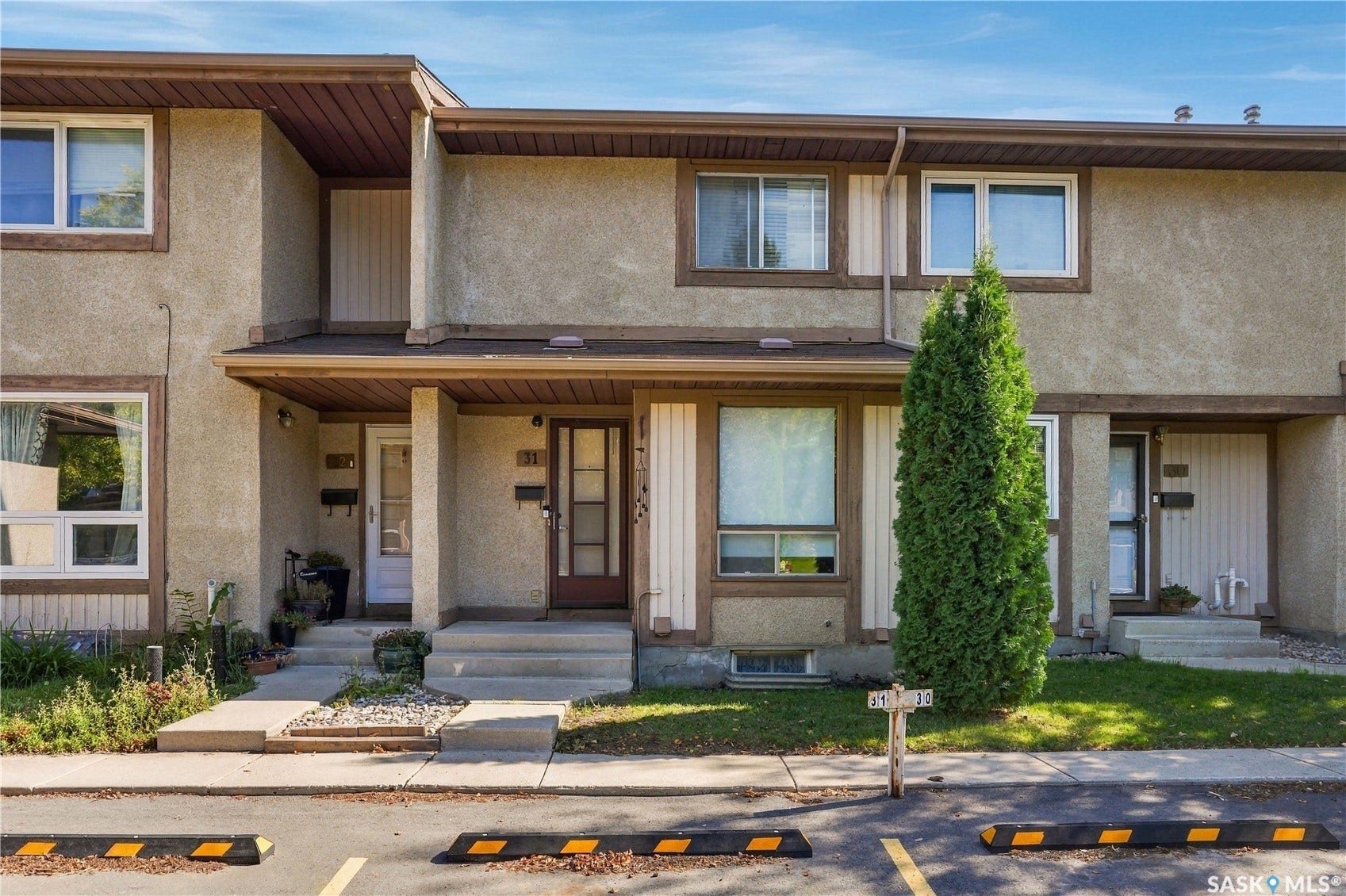 Stucco exterior with brown trim accents