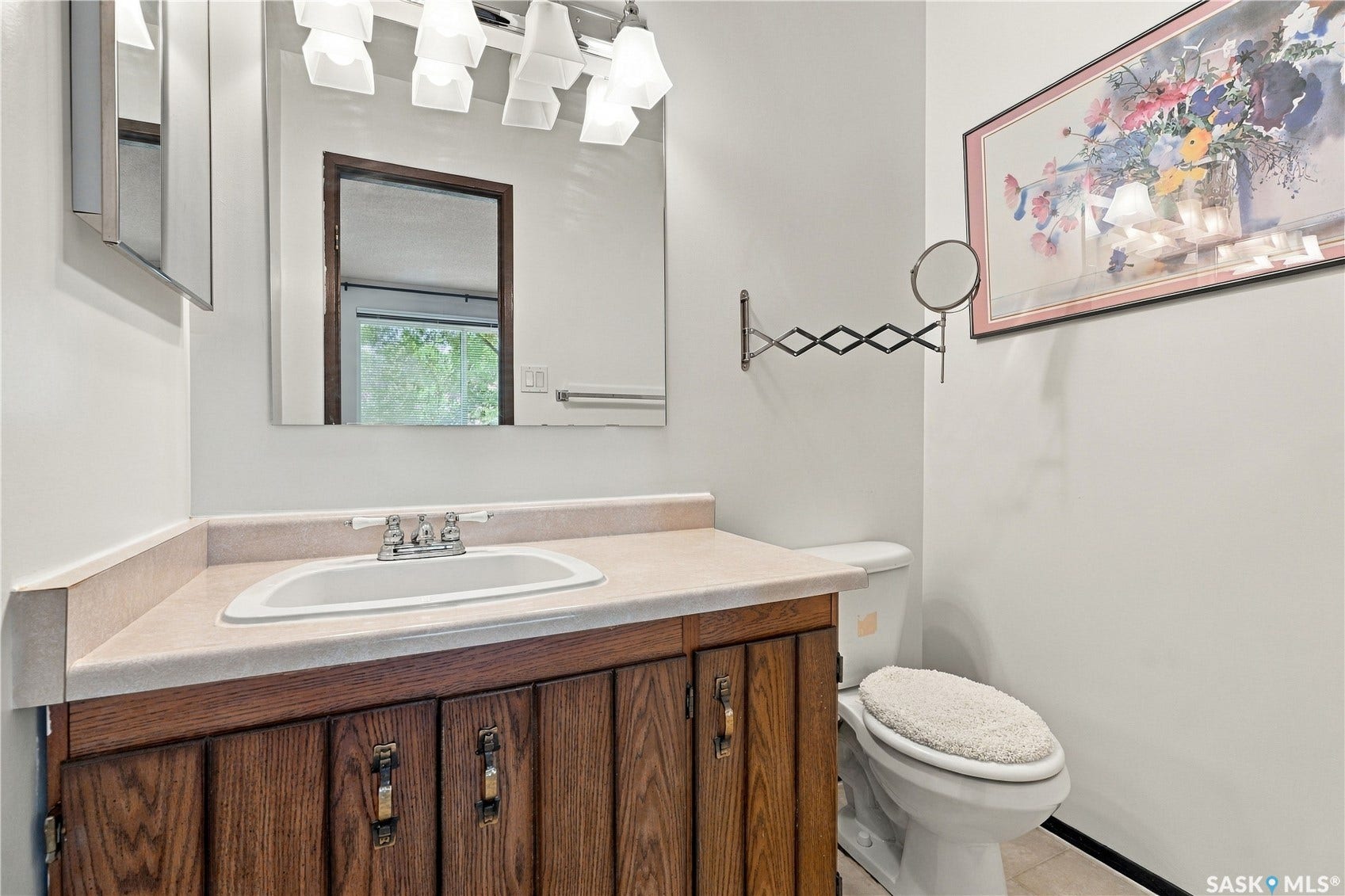 Wood-finish vanity with an integrated sink and light-toned countertop