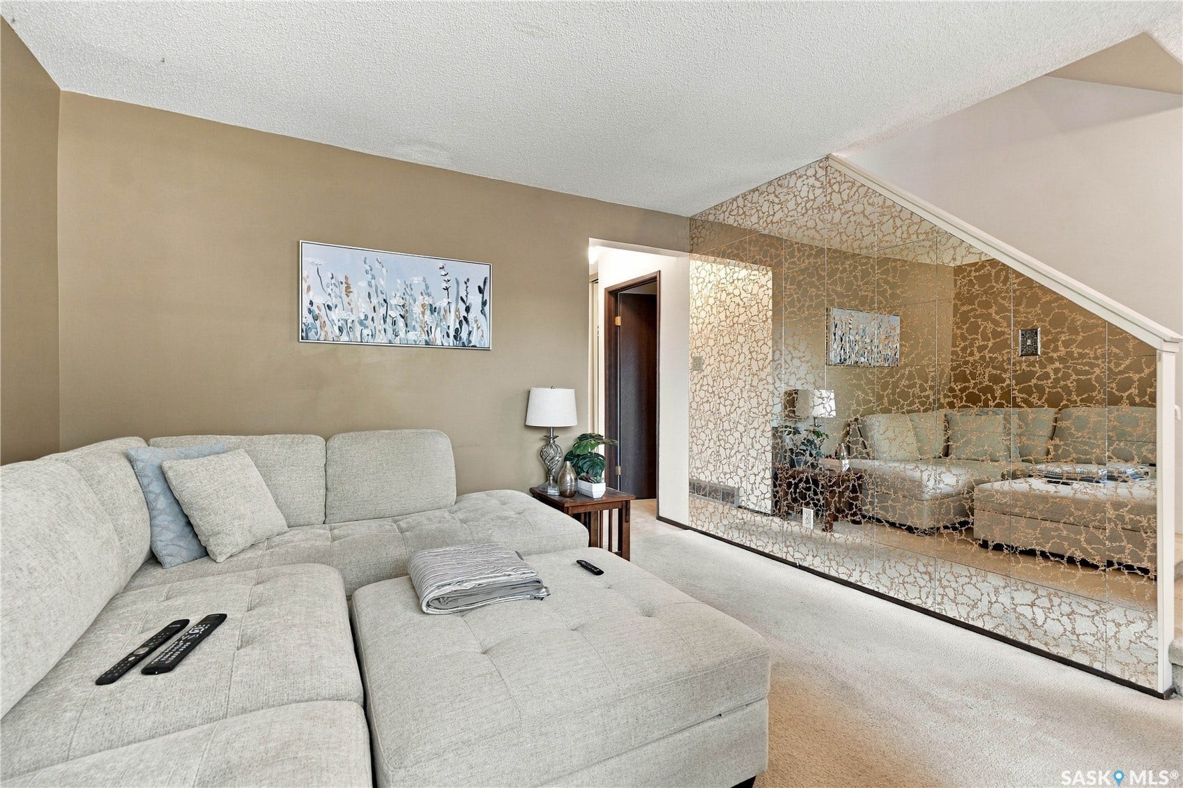 Textured wall paneling with a mirrored accent wall