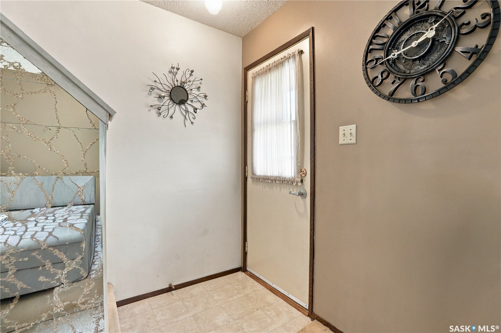 Entryway featuring a paneled door with a privacy curtain, and carpet flooring