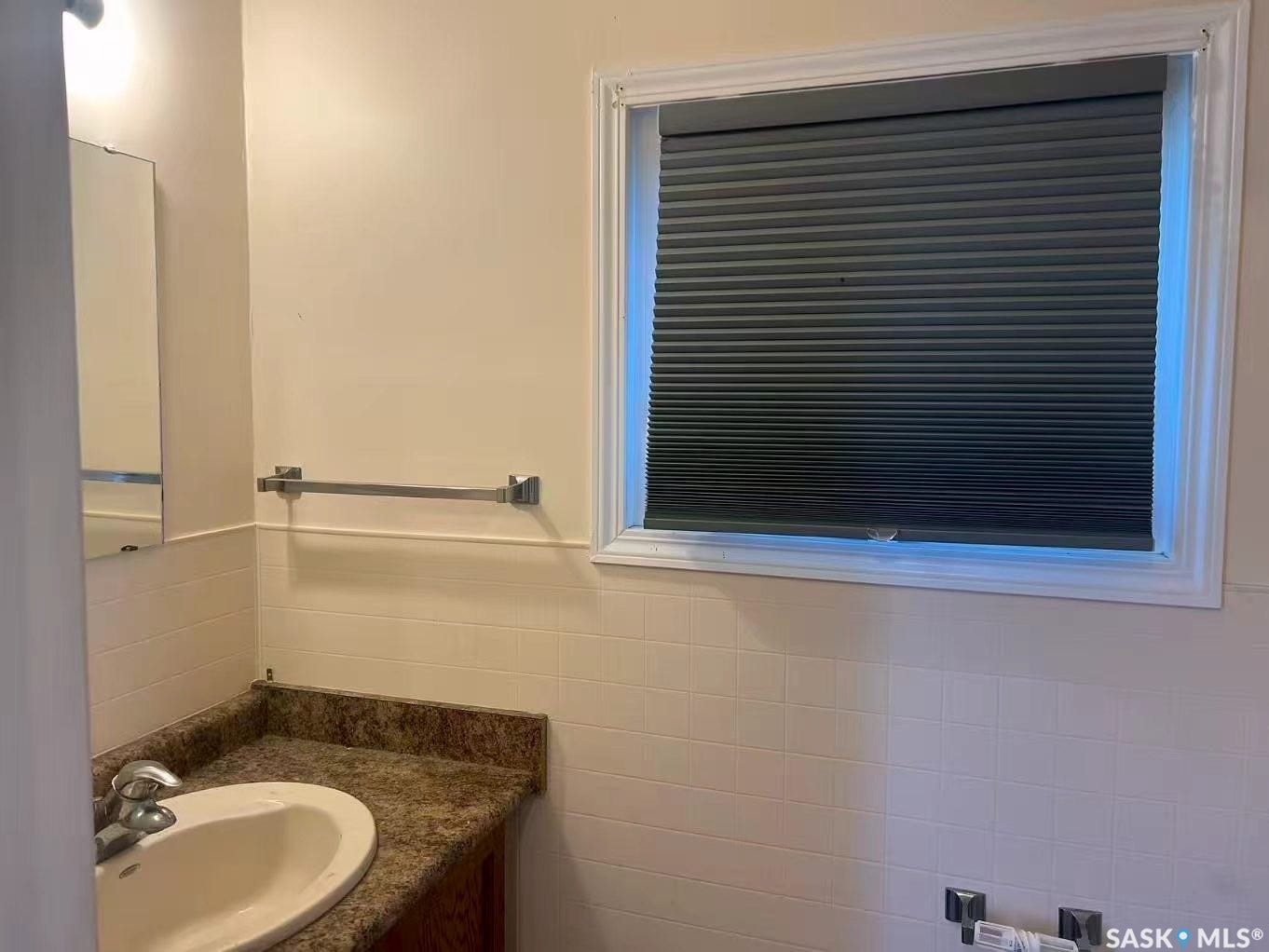 Vanity with integrated sink, speckled countertop, and chrome faucet
