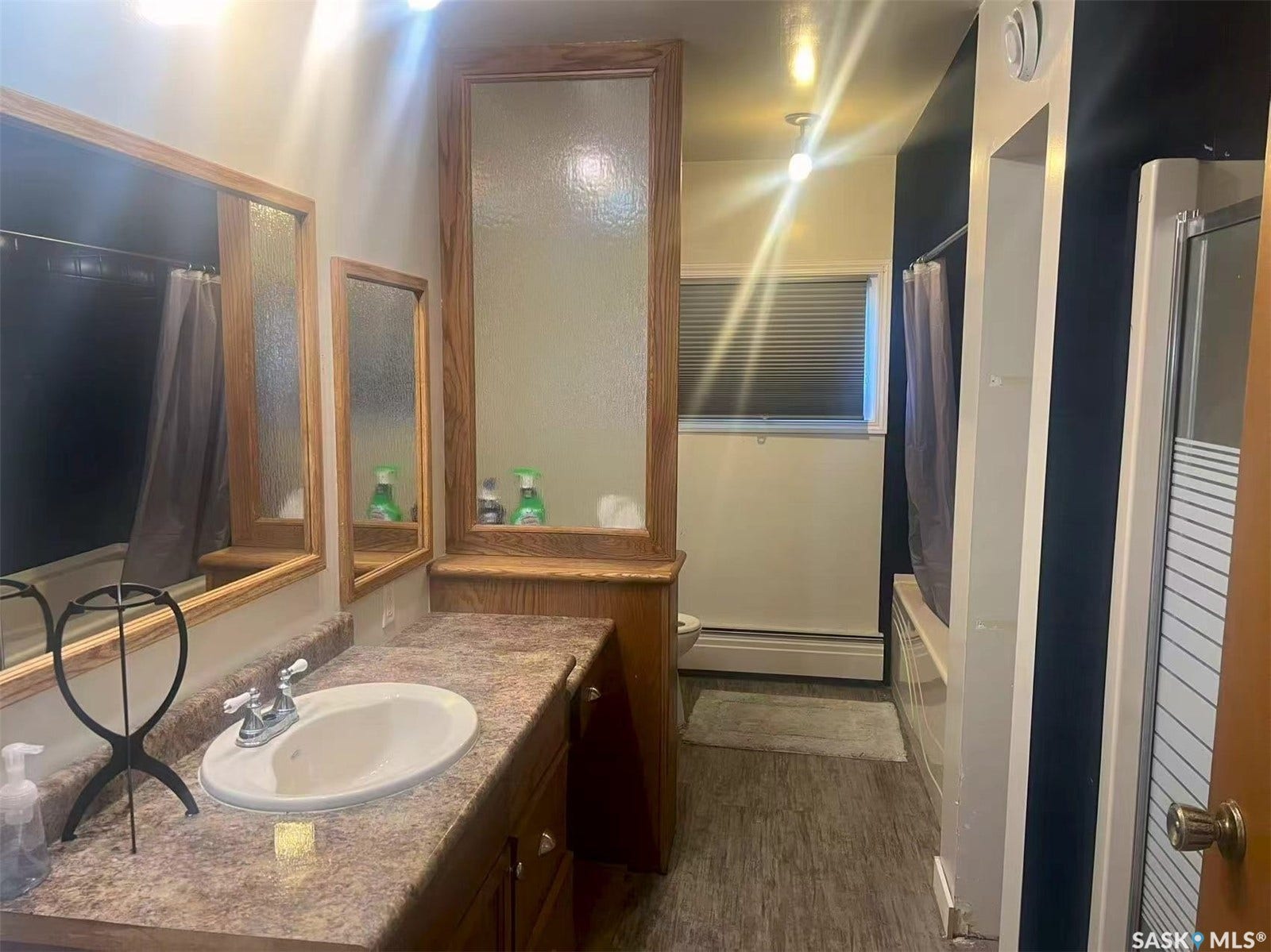 Wood-finish vanity with an integrated sink and chrome faucet