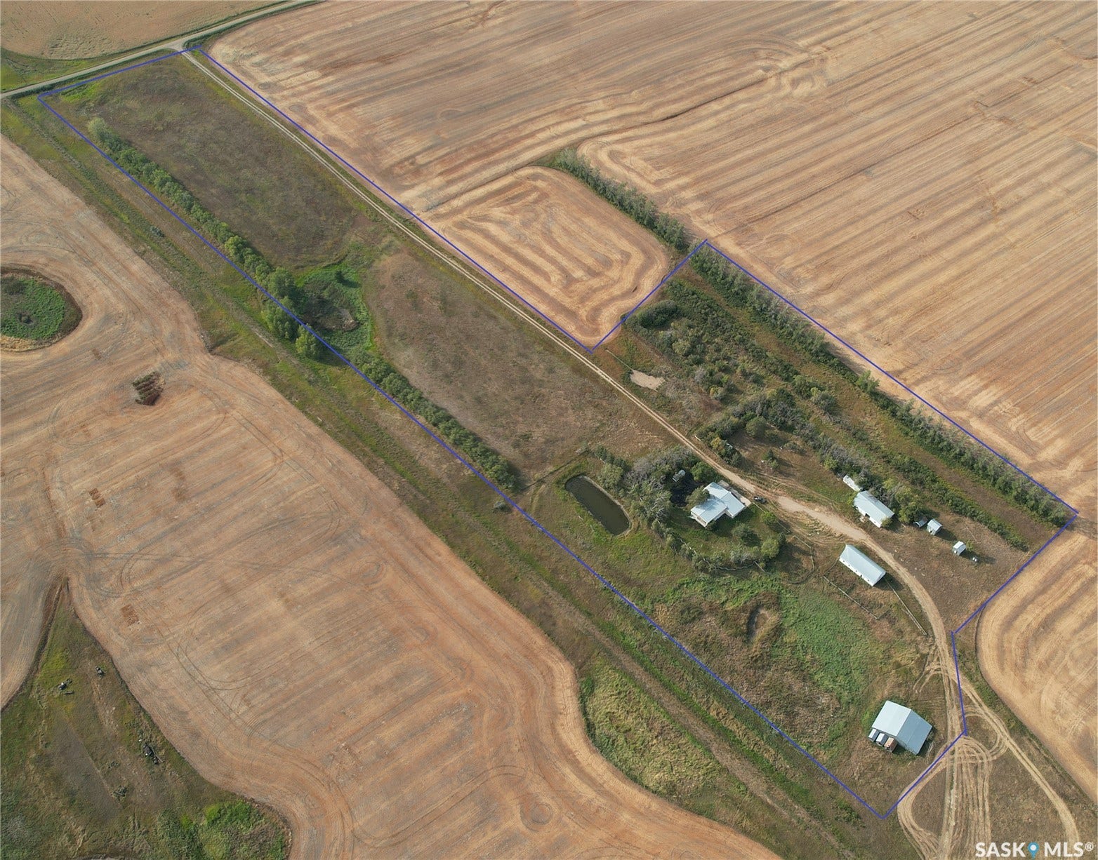 Agricultural land with a main residence, multiple outbuildings, and two visible ponds