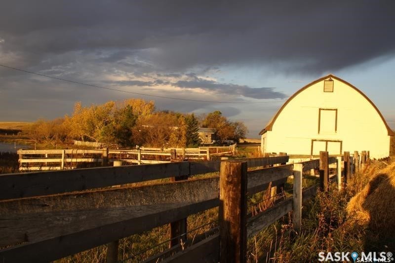 White gambrel roof barn with dark trim