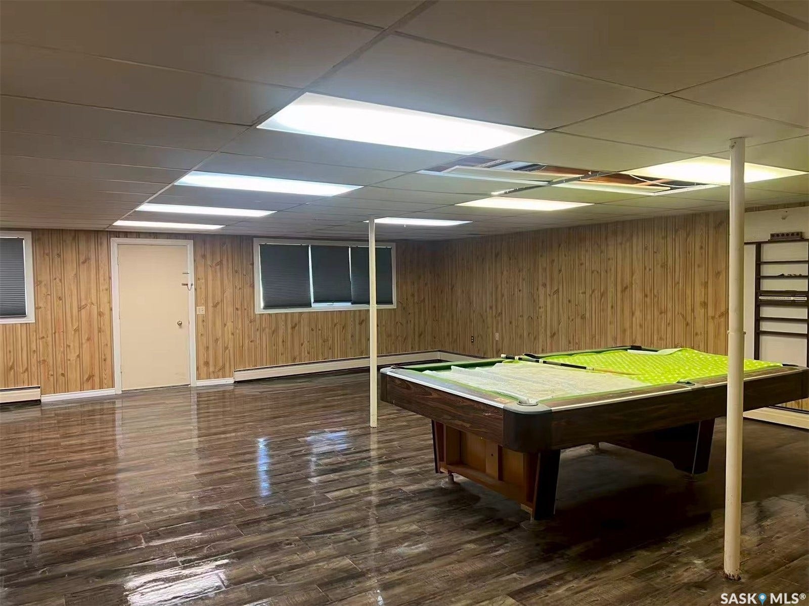 Wood-finish flooring and paneled walls create a distinct ambiance