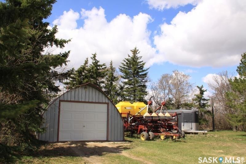 Quonset hut-style garage with a white overhead door