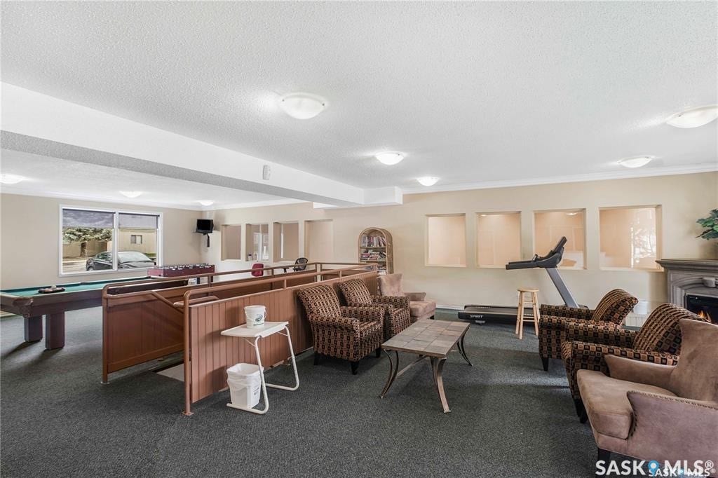 Recreation room with carpet flooring.