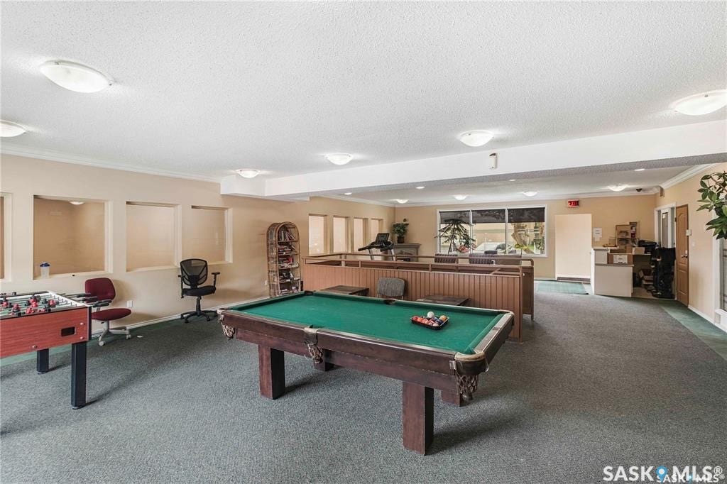Recreation room featuring carpet flooring, recessed wall niches, and perimeter lighting