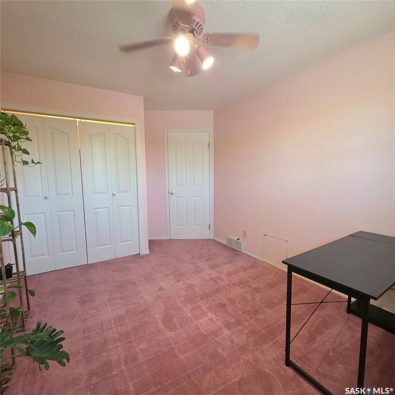 Ceiling fan with integrated lighting, wall-to-wall carpeting, two panel doors, and two bi-fold closet doors