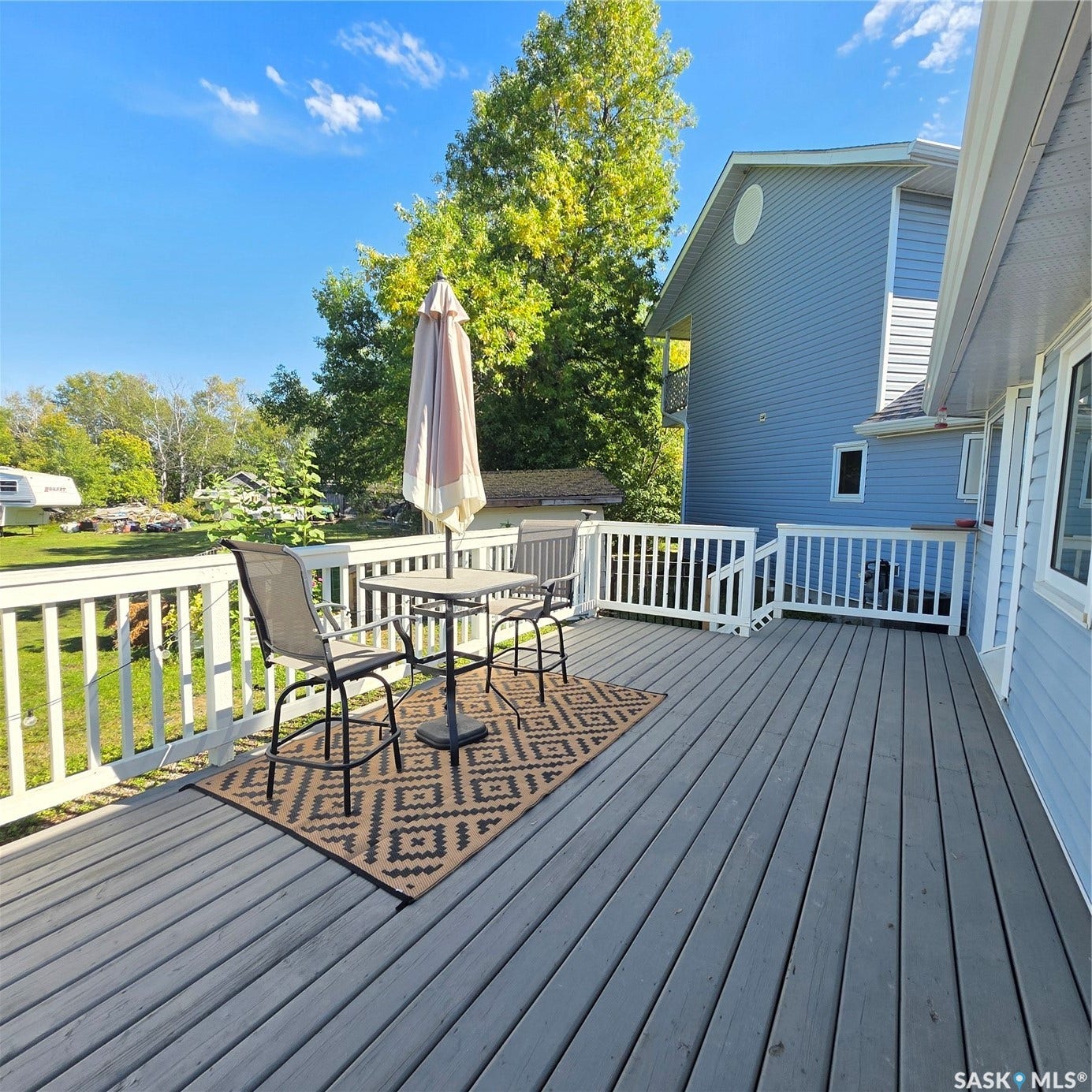 Expansive outdoor deck featuring wood flooring and white railings