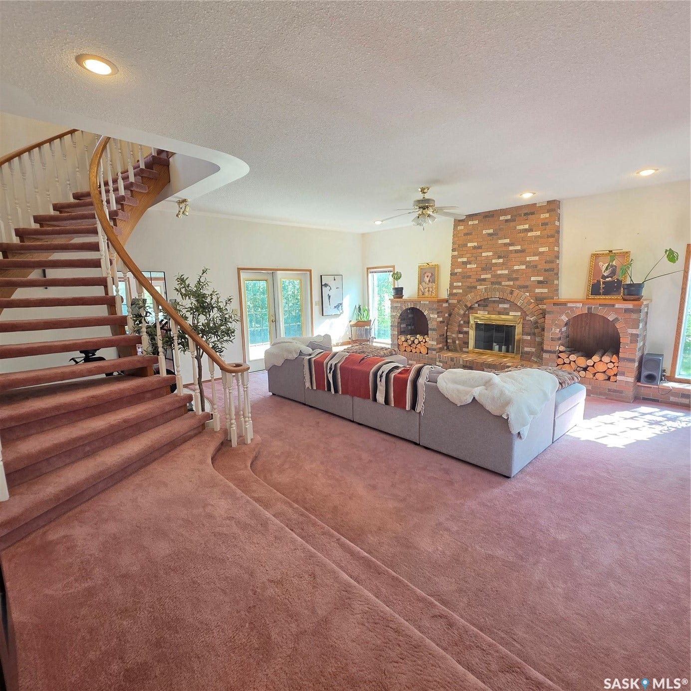 Grand staircase with wood-finish handrail and painted spindles