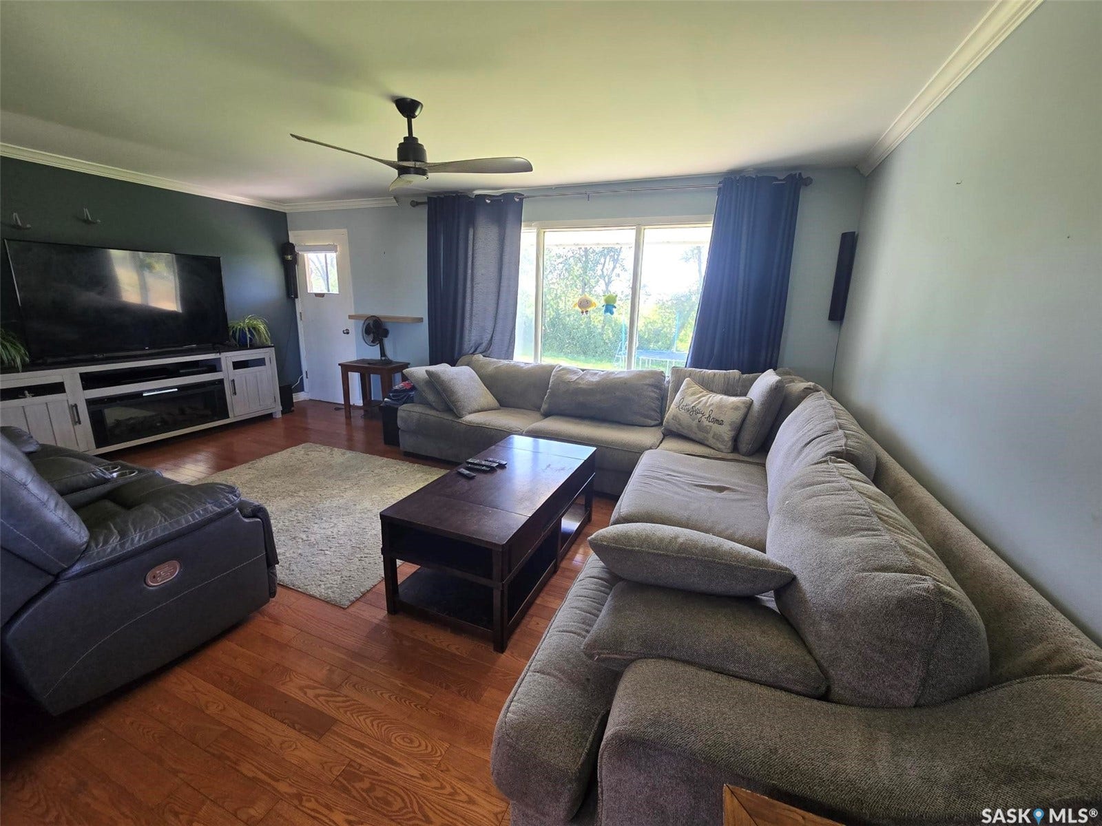 Hardwood flooring, crown molding, ceiling fan, and sliding glass door