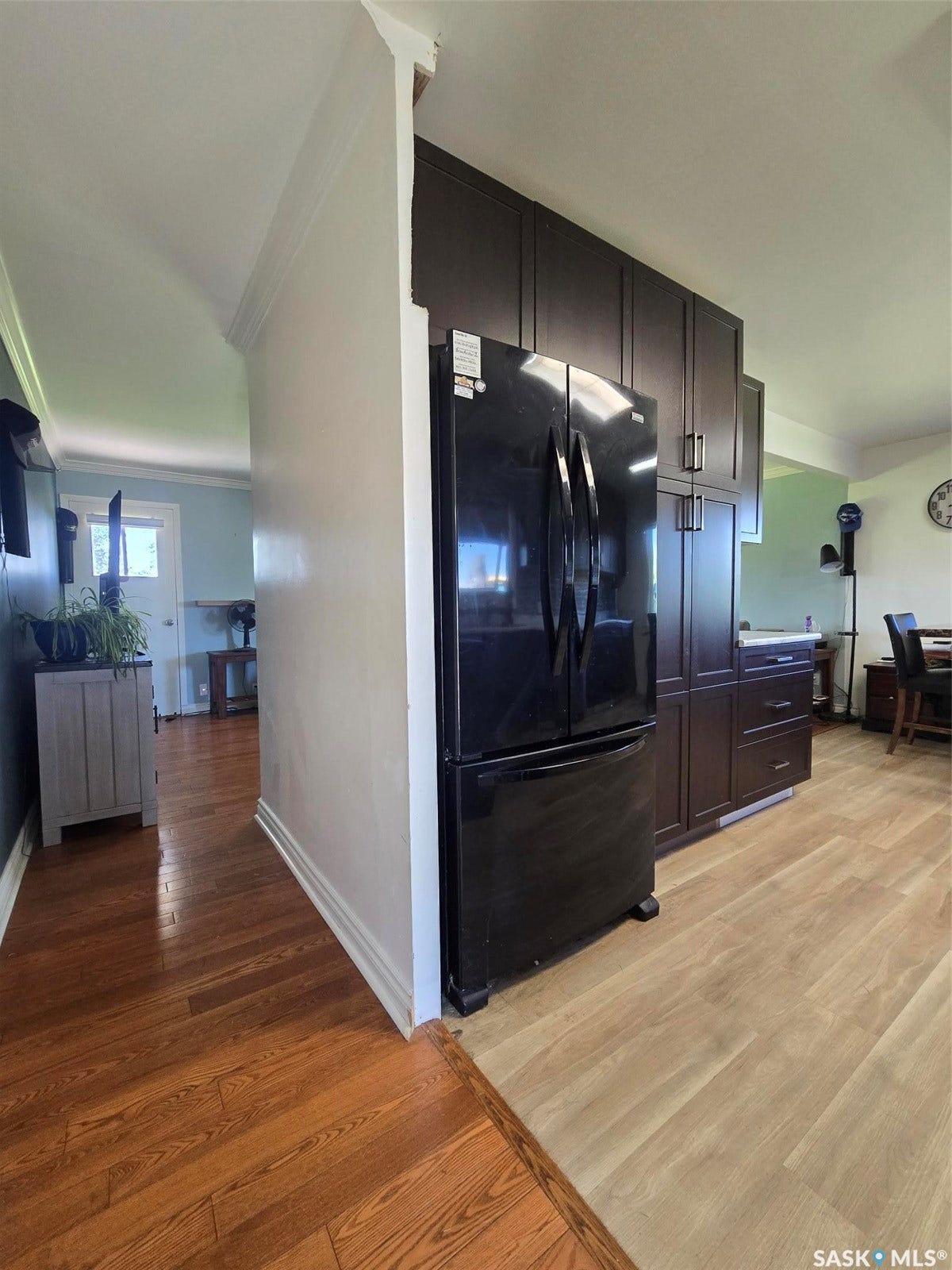 Rich wood-finish flooring, dark wood-finish cabinetry, and light wood-finish flooring