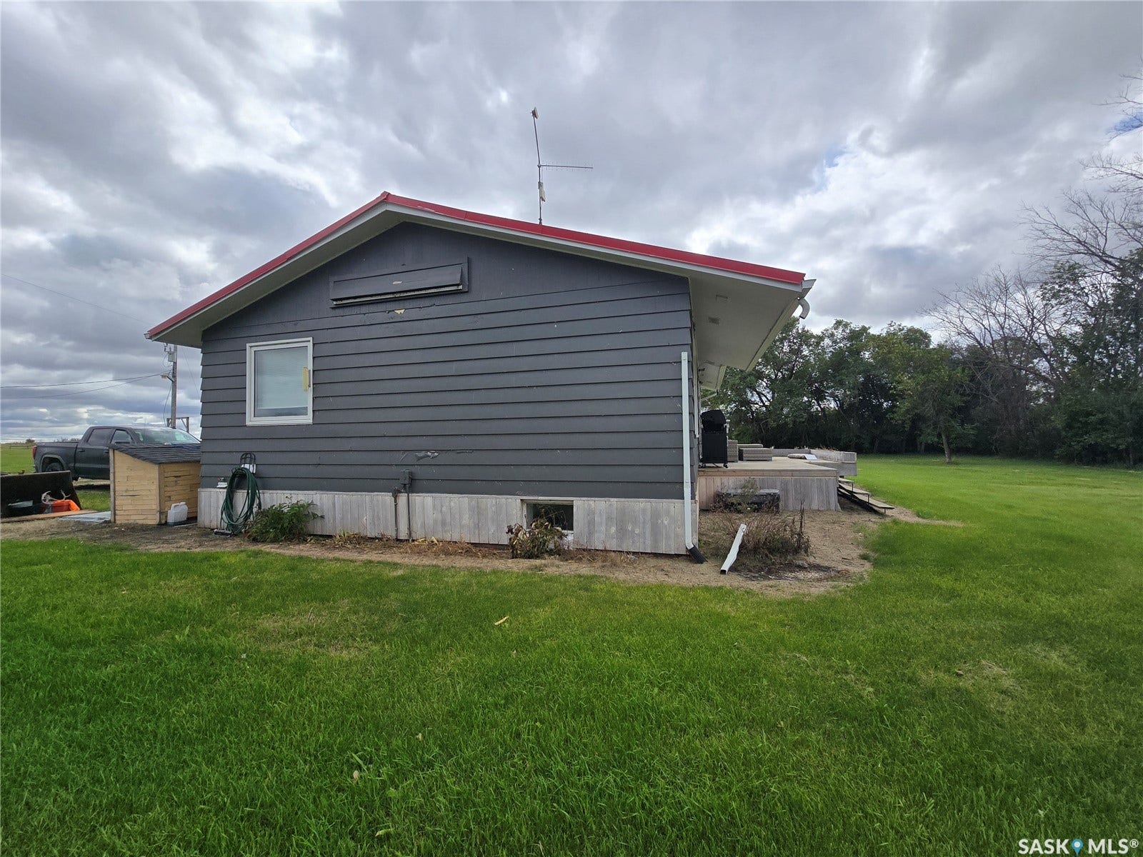 Gray horizontal siding with red trim roof