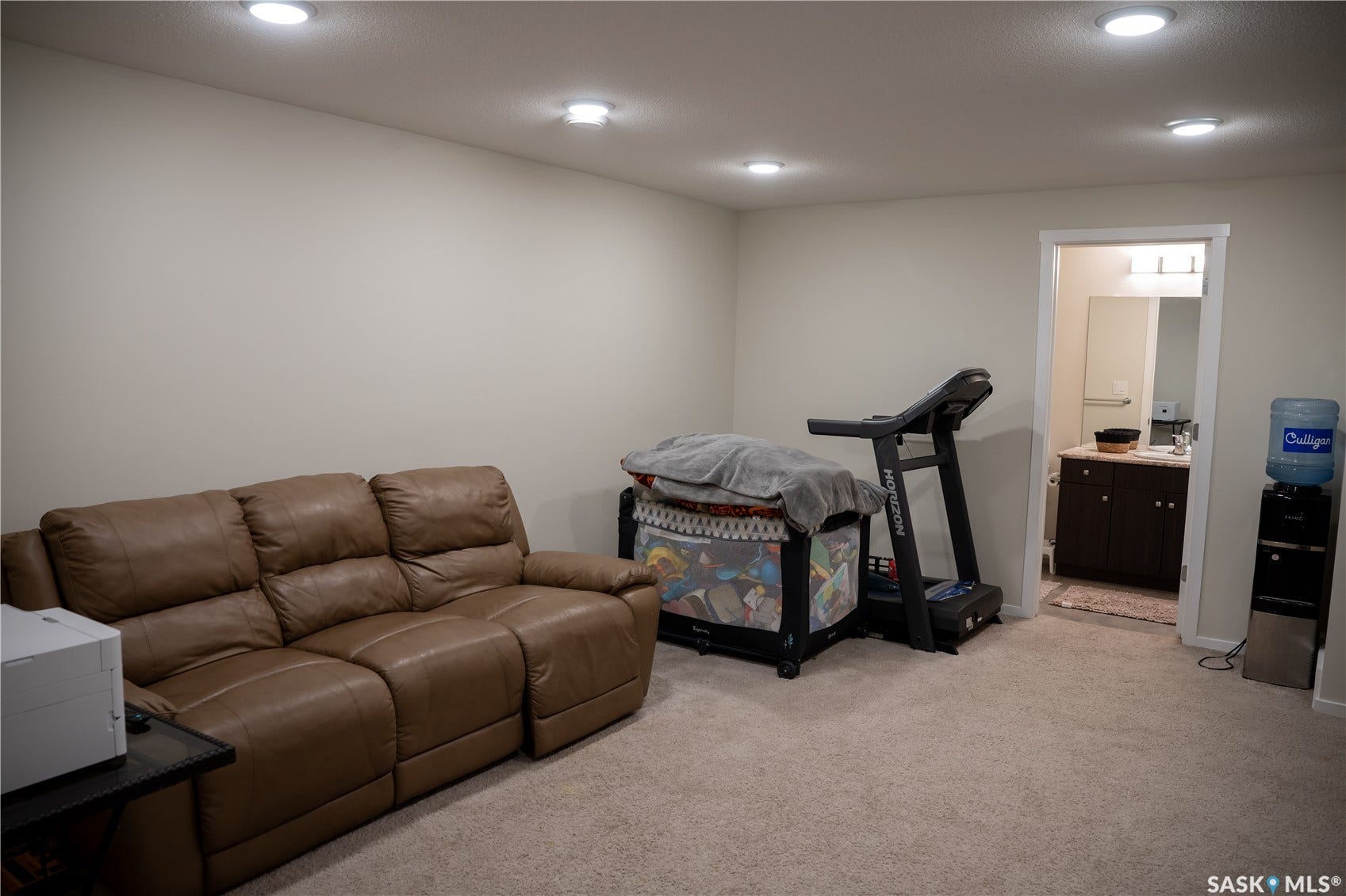 Recessed lighting, neutral wall paint, and carpeting throughout