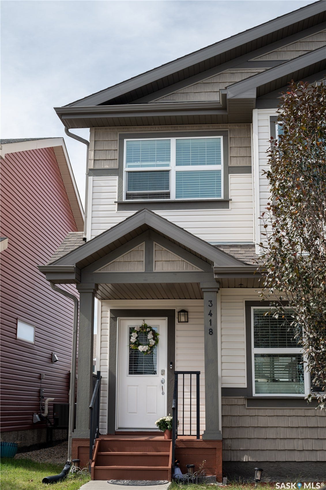 Two-story facade featuring horizontal siding and shingle accents