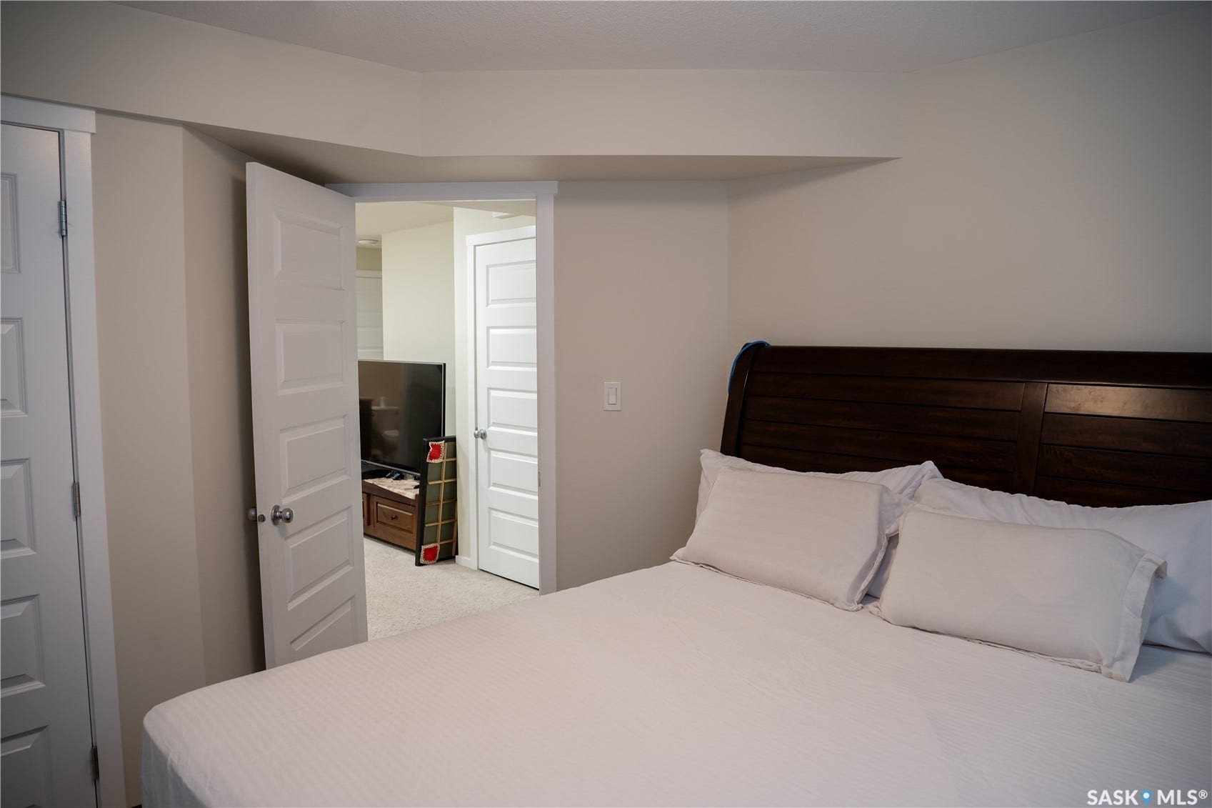 White interior doors, light-colored wall paint, and recessed ceiling lighting