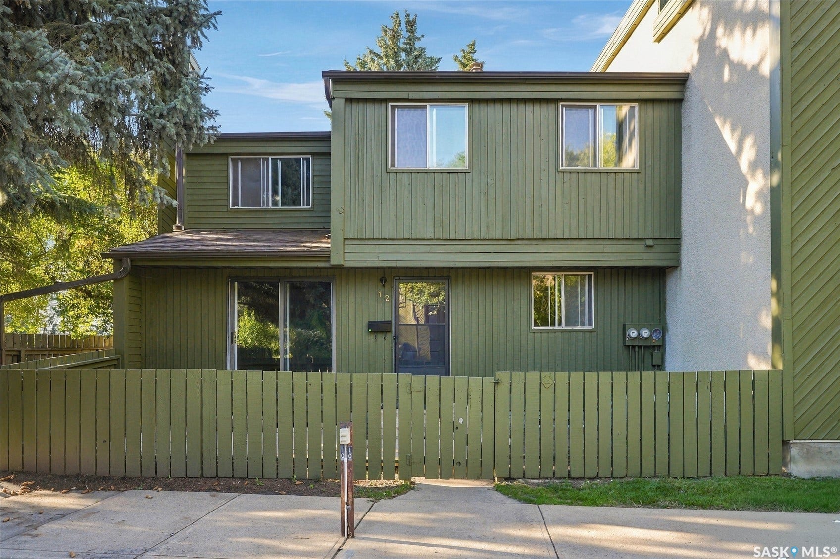 Two-story exterior with vertical siding and stucco accents