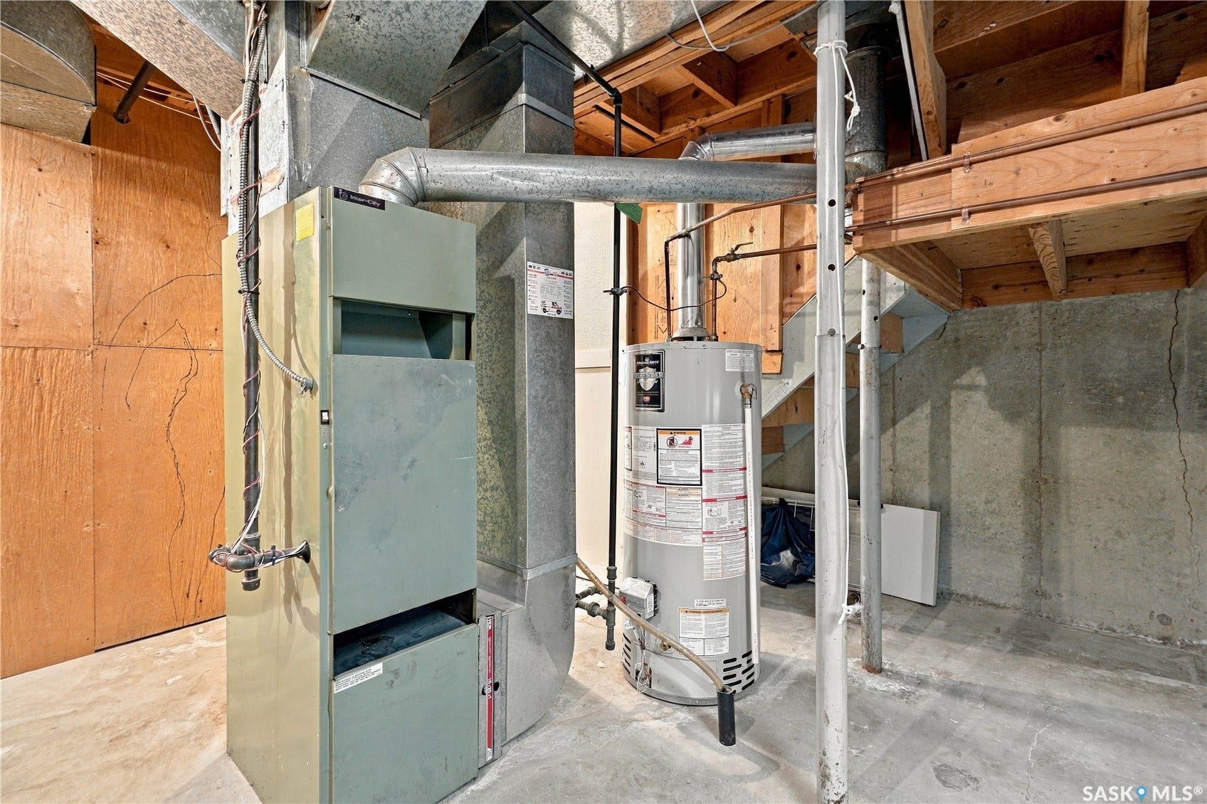 Furnace and water heater systems with exposed ductwork, concrete flooring