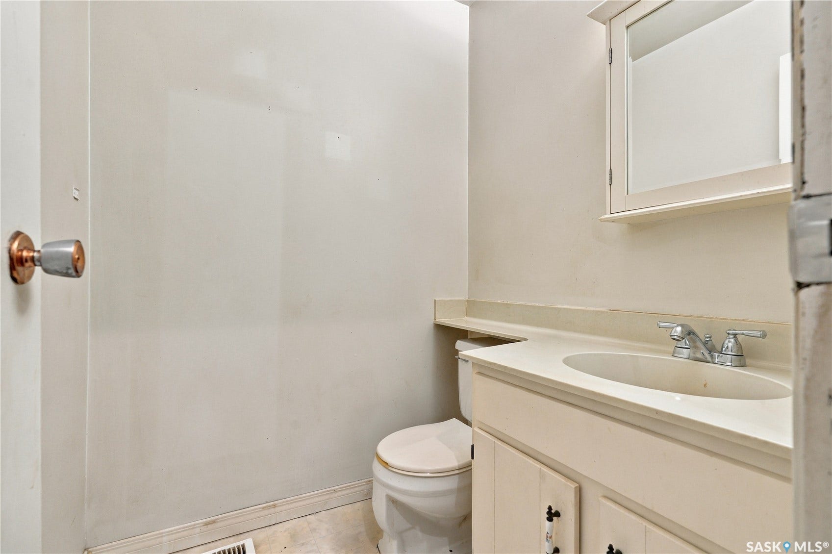 Vanity with integrated sink, chrome faucet, and mirrored medicine cabinet